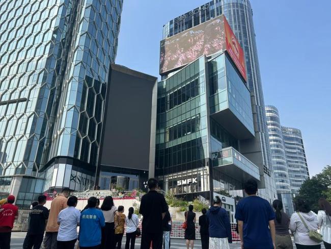 大屏幕转播阅兵仪式路人驻足